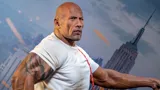 Dwayne Johnson wax figure with an action-packed backdrop for an immersive movie-like experience.